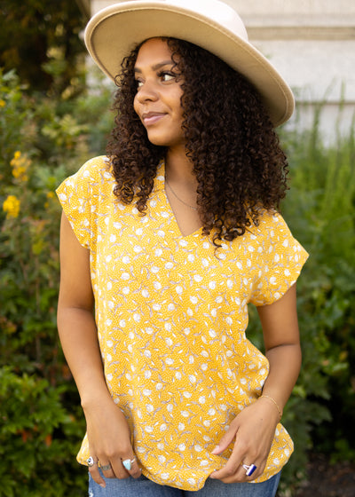 Short sleeve marigold floral top with a v-neck