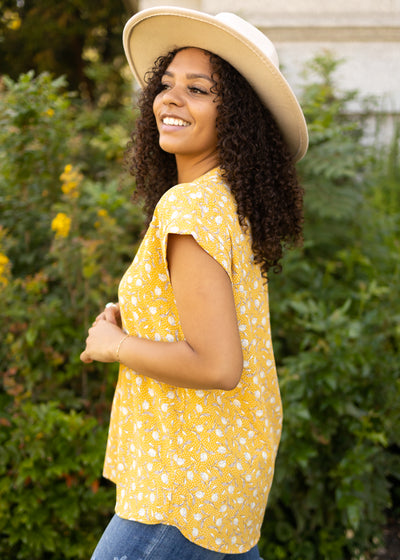 Side view of a marigold floral top
