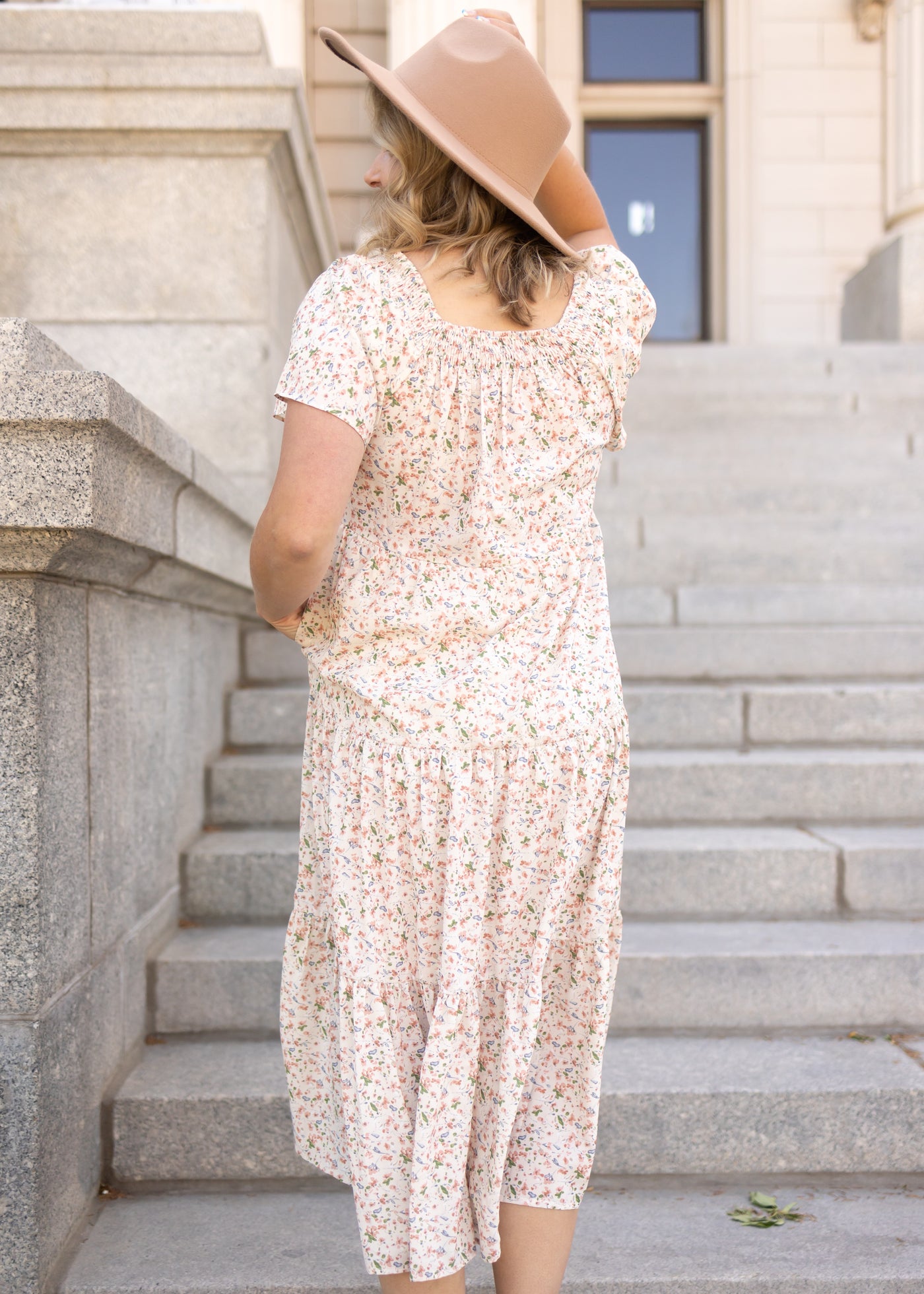 Back view of a short sleeve cream floral dress
