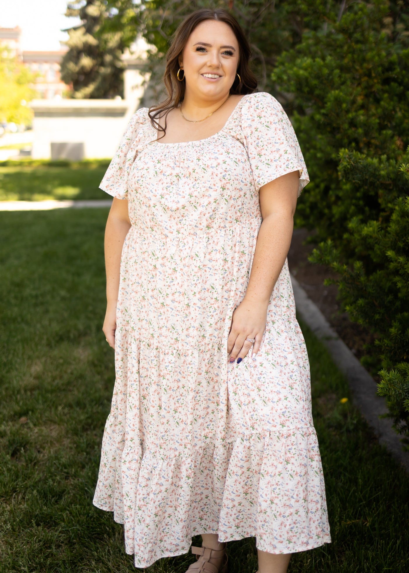 Plus size cream floral dress with short sleeves and tiered skirt