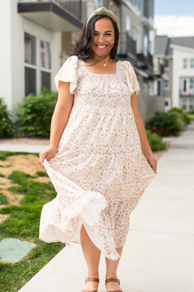 Side view of a short sleeve cream floral dress