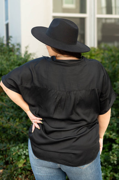 Back view of a black top with gather detail
