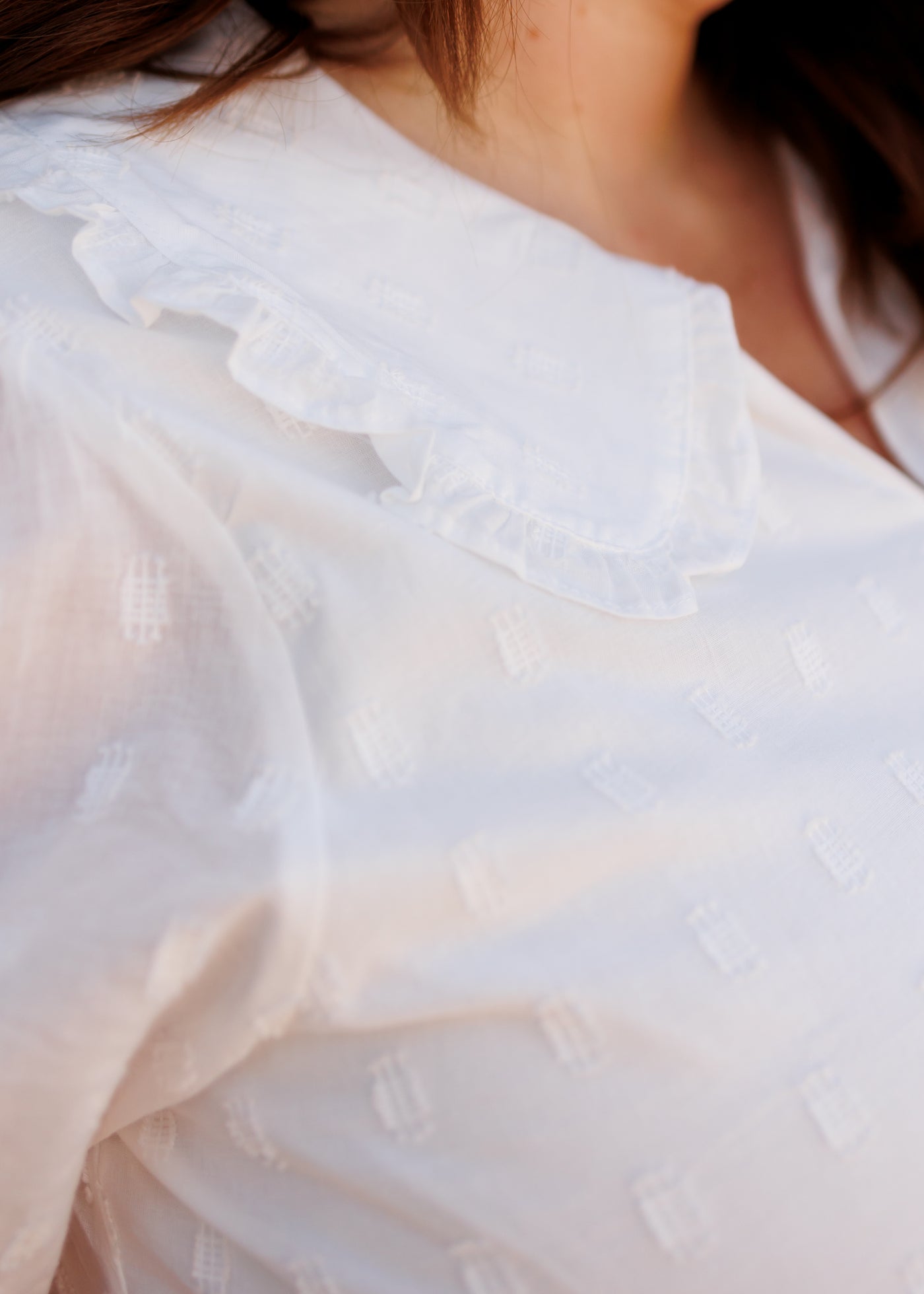 Close up of the collar and fabric on the ivory mini dress