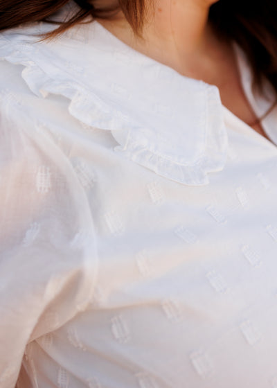 Close up of the collar and fabric on the ivory mini dress