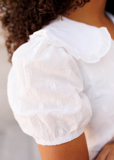 Close up of the sleeve and fabric on the ivory mini dress