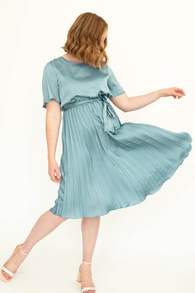 French blue satin dress with pleated skirt and ties at the waist