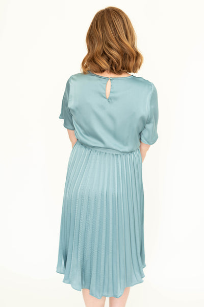 Back view of a french blue short sleeve satin dress with pleated skirt