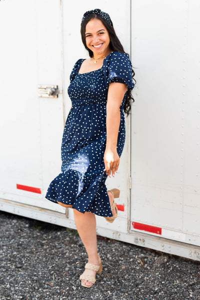 Navy square neck dress with short sleeve with a ruffle at the bottom