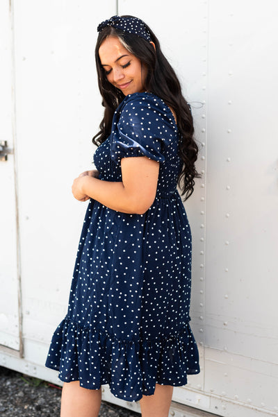Side view of a navy square neck dress with short sleeve