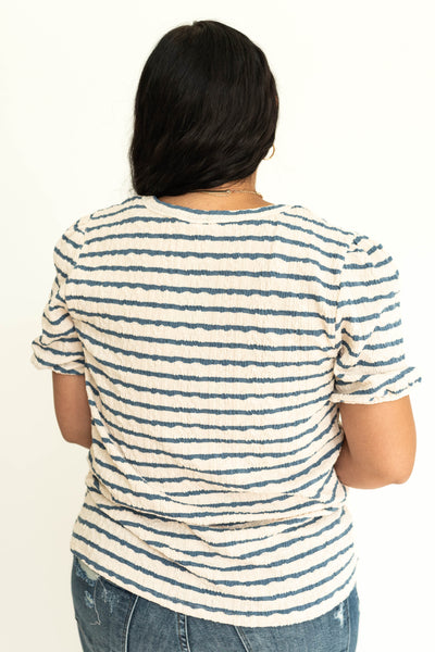 Back view of a ivory and blue stripe top.