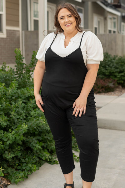 Plus size black jumpsuit with tapered legs and slight v-neck