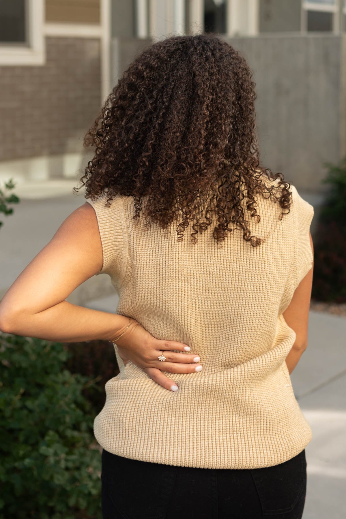 Back view of a camel sweater vest
