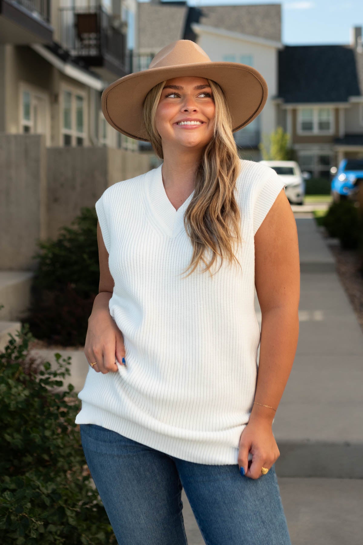 White sweater vest with a cuff around the sleeve
