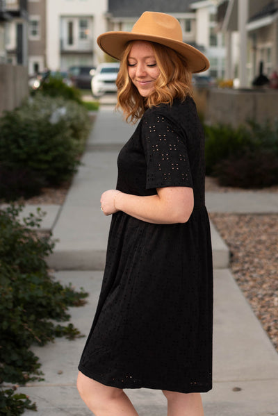 Side view of a black eyelet dress