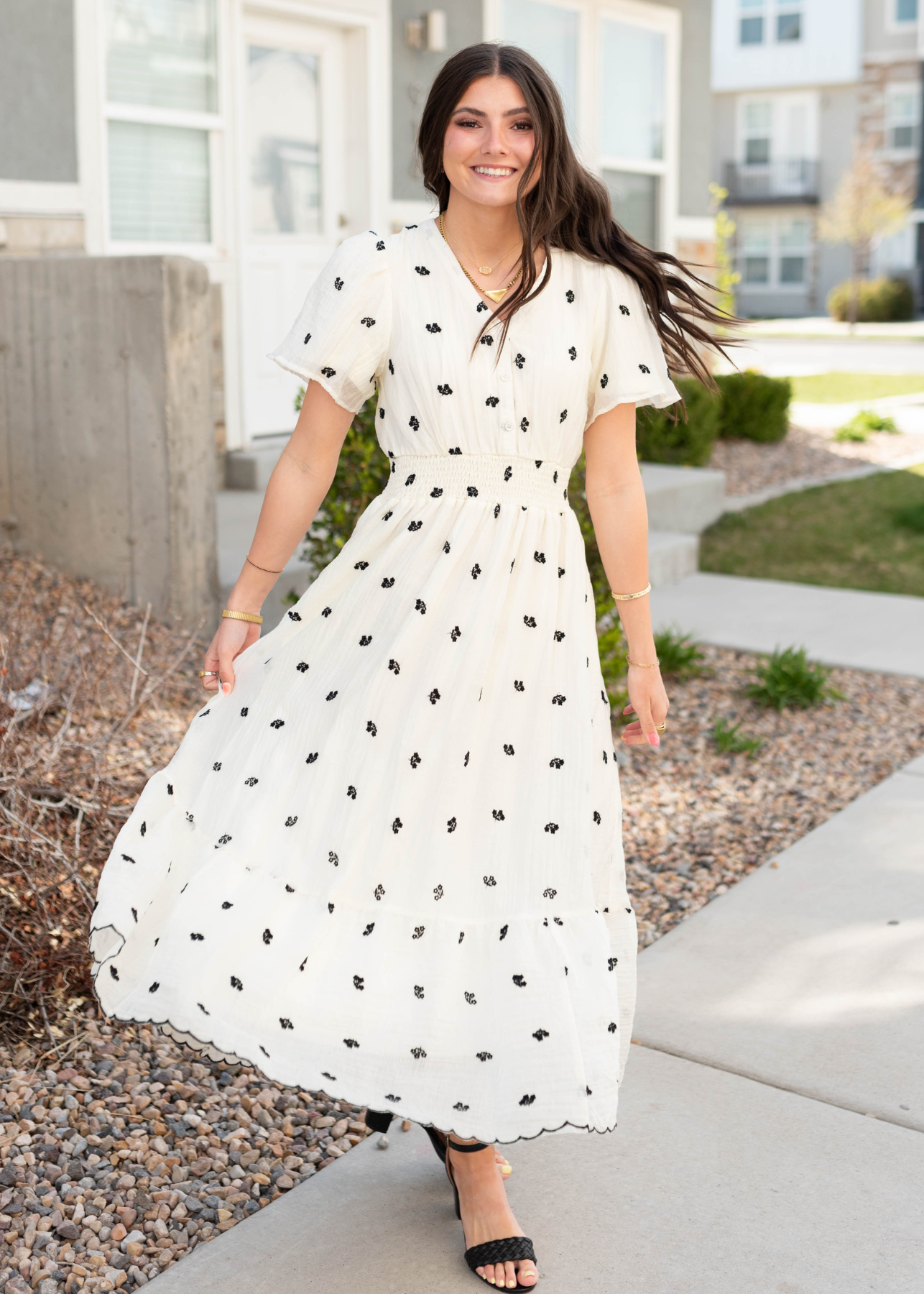 Black flowers on the ivory embroidered dress