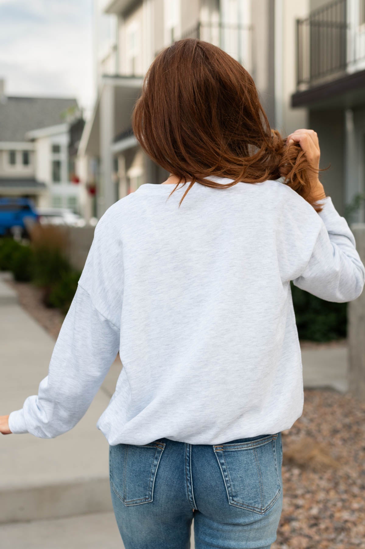 Back view of a long sleeve wanderlust grey pullover