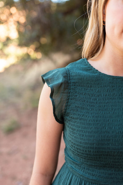 Close up of a hunter green dress
