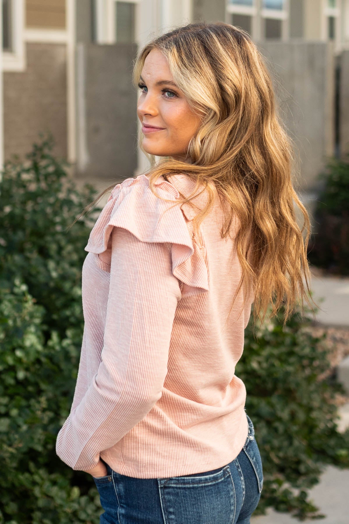 Side view of a long sleeve mauve top