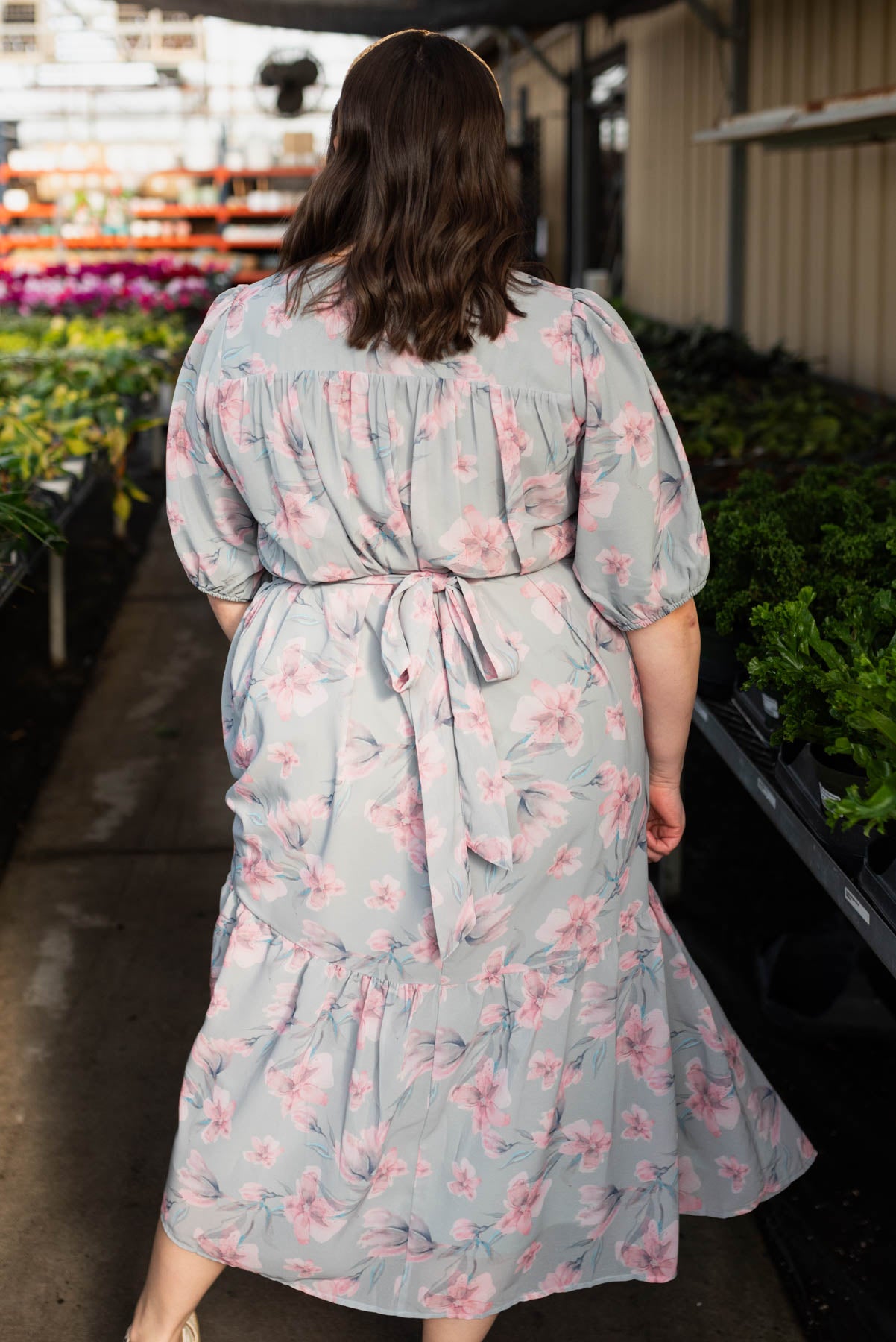 Back view of the plus size sage grey watercolor floral dress that ties in the back