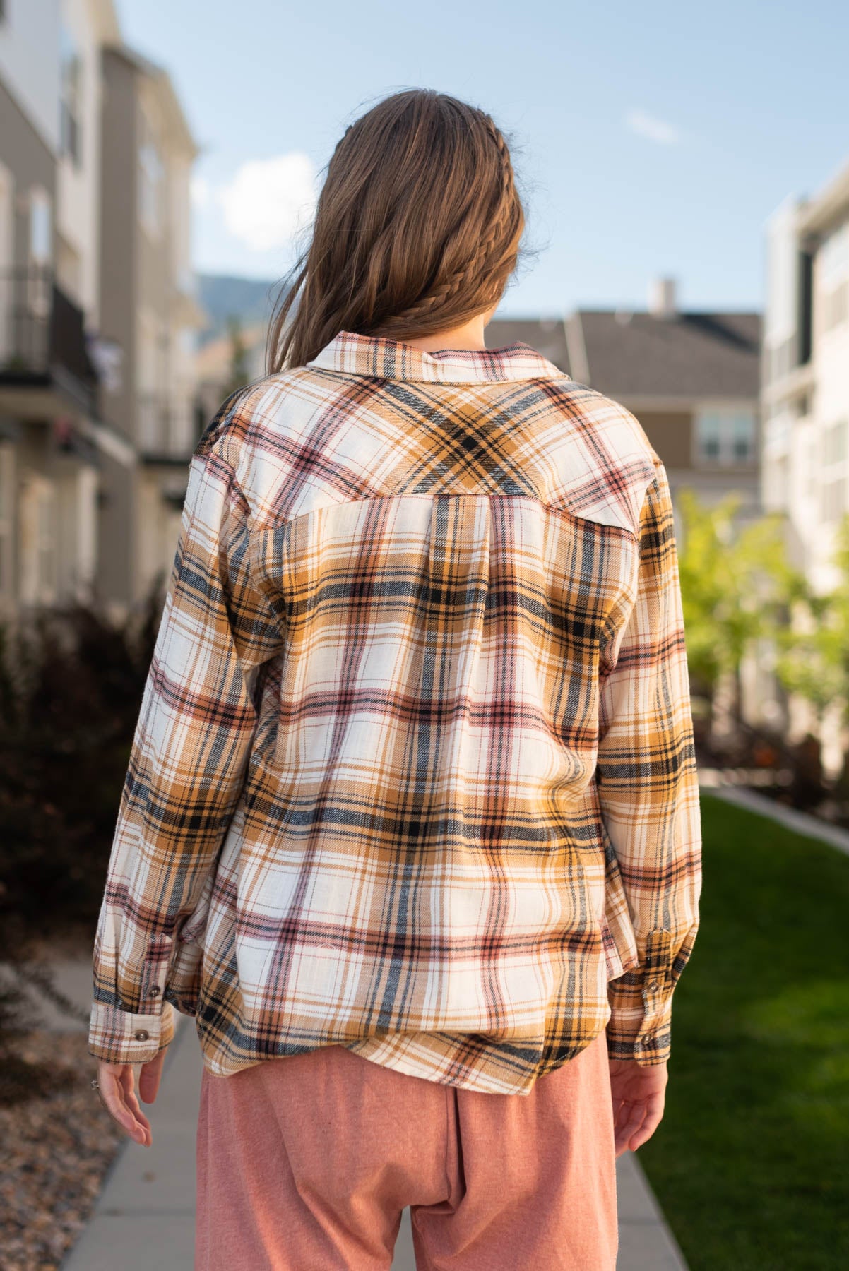 Back view of a saffron plaid top