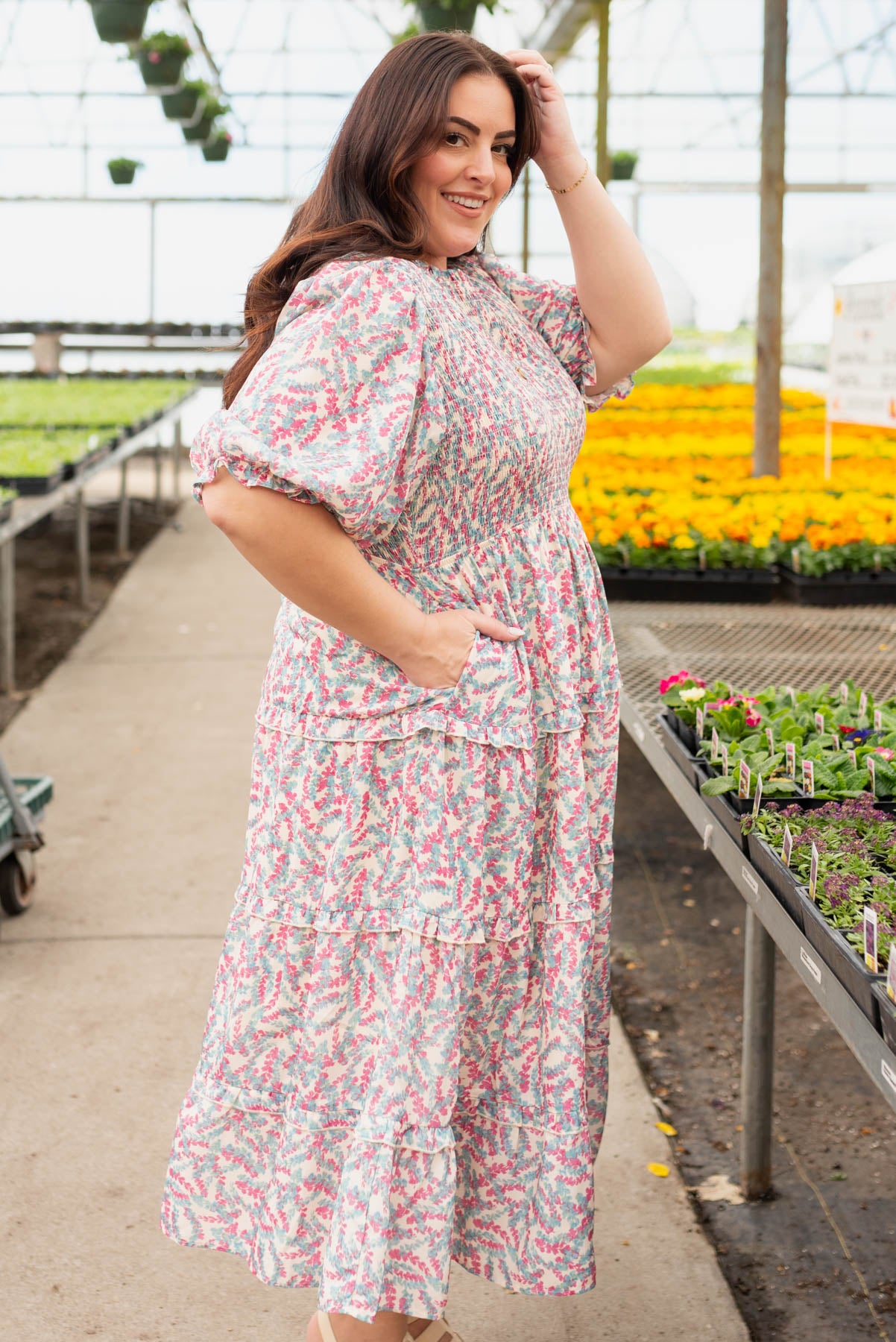 Side view of the plus size blue floral smocked dress with pockets