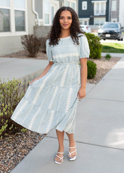 White embroidery on the light blue embroiered dress