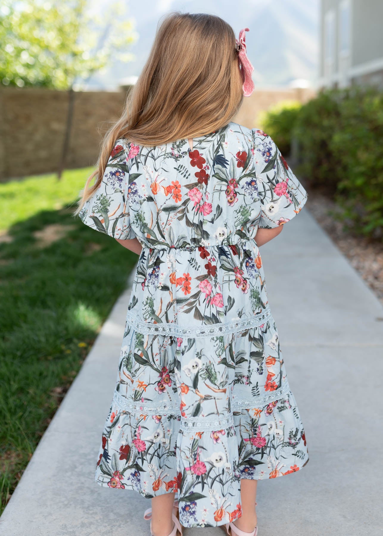 Back view of the blue floral tiered little girl dress