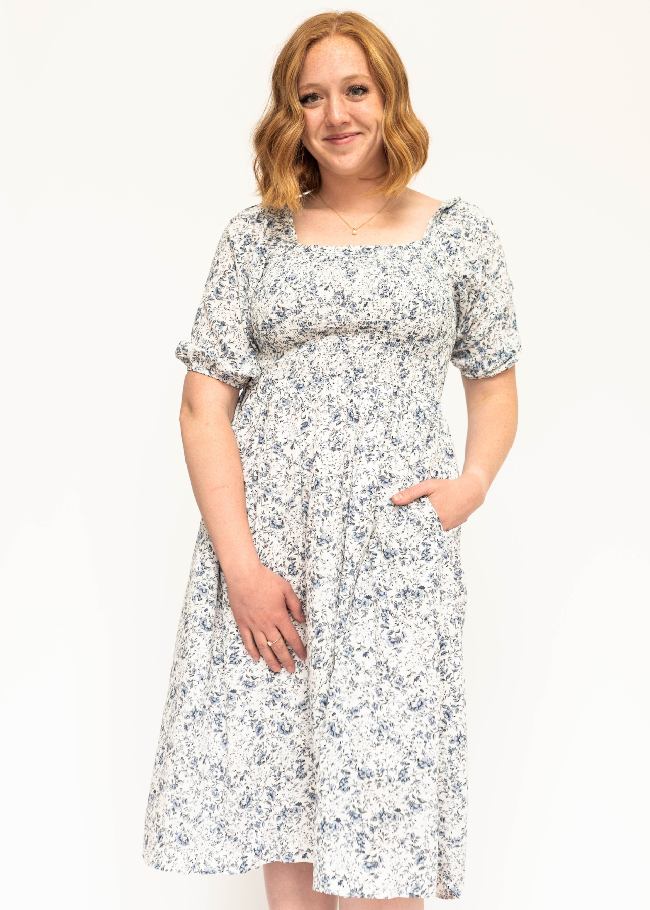 Blue and white short sleeve floral dress with a smocked bodice.