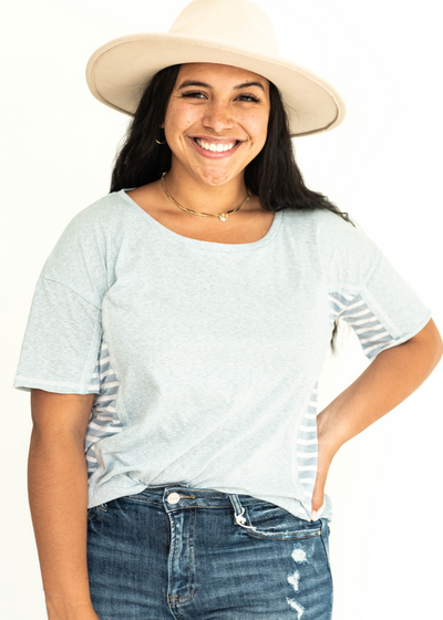 Short sleeve soft blue top with stripes on the sides.