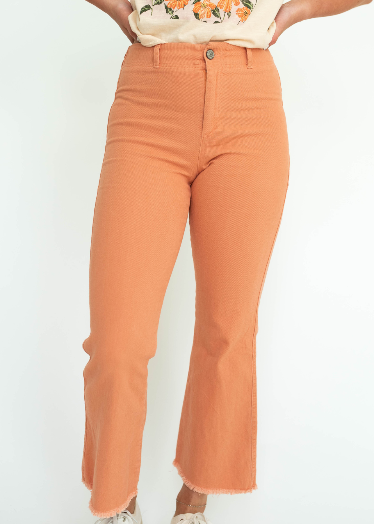 Ginger ankle length pants with a frayed edge.