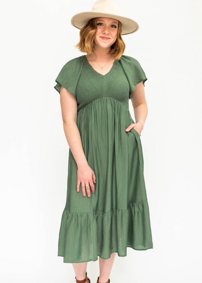 Buttercream satin dress with a V-neck and smocked bodice.