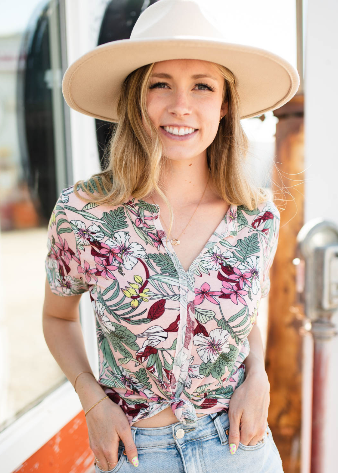 Short sleeve pink floral top that buttons up and has a v-neck.