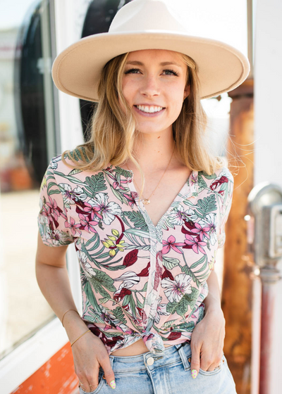 Short sleeve pink floral top that buttons up and has a v-neck.