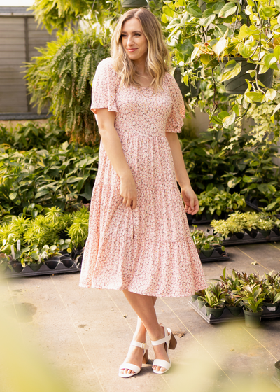 Short sleeve blush floral dress with tiered skirt and smocked bodice