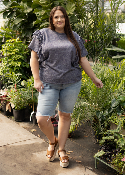 Front view of a plus size denim blue top