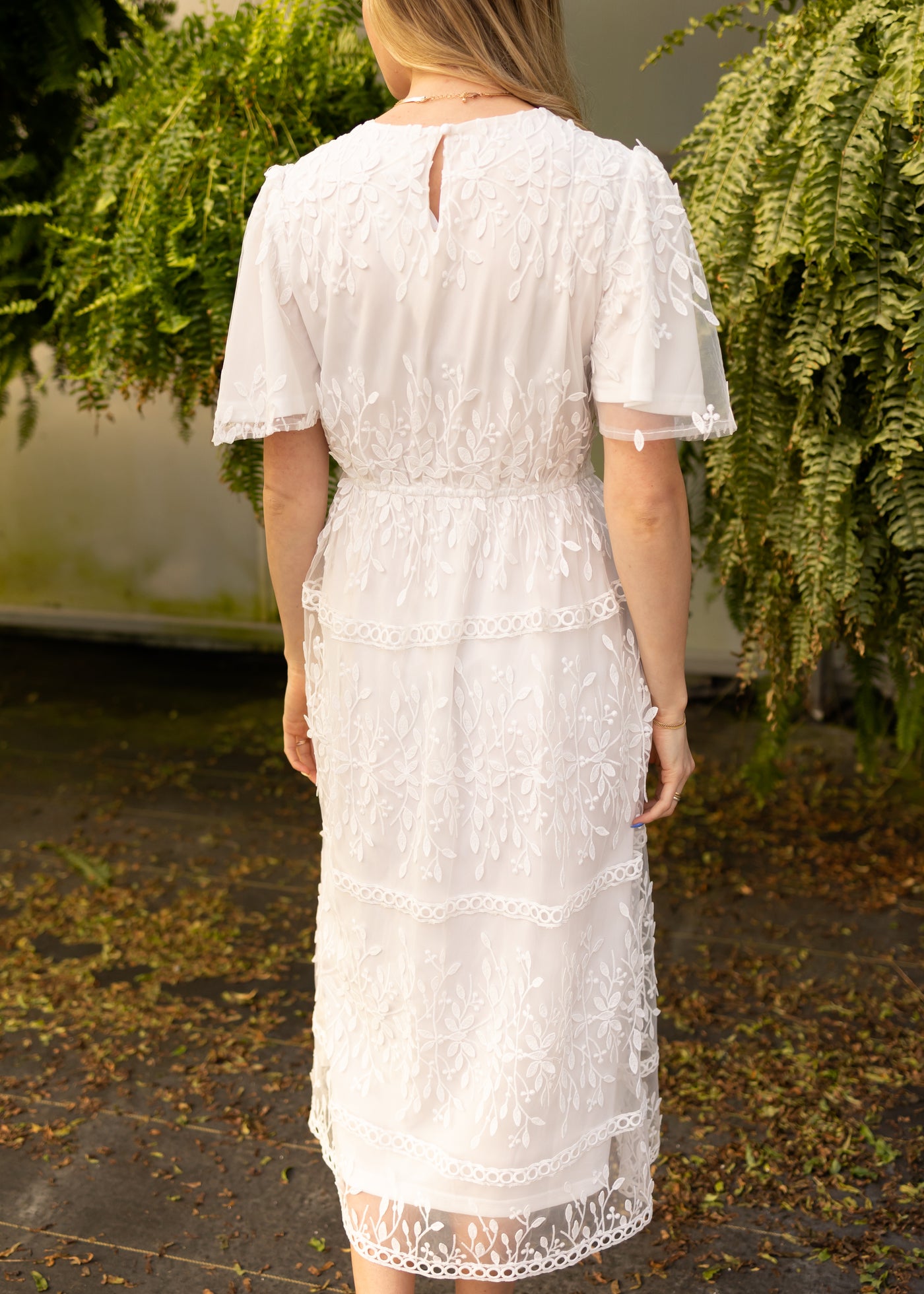 Back view of a white floral dress