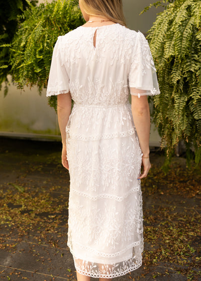 Back view of a white floral dress