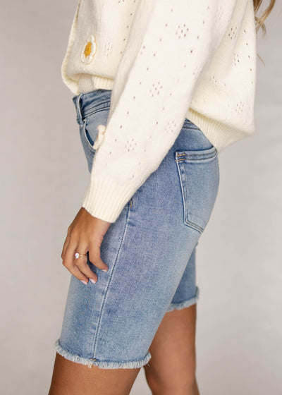 Side view of medium wash shorts