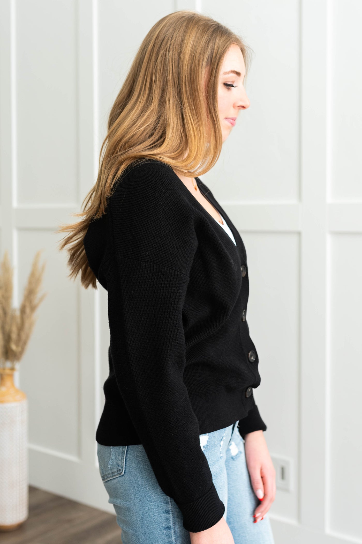 Side view of a black cardigan