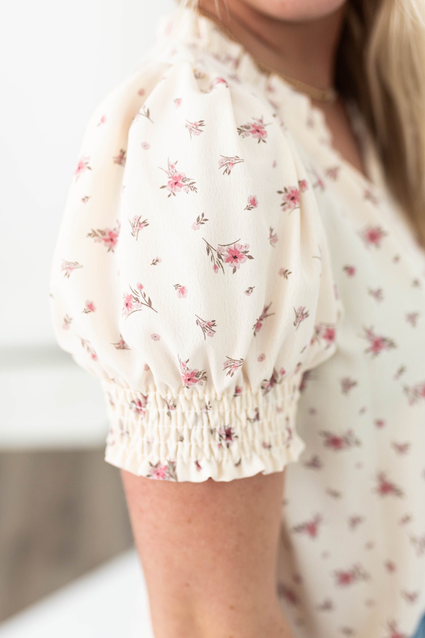 Sleeve of a cream floral top