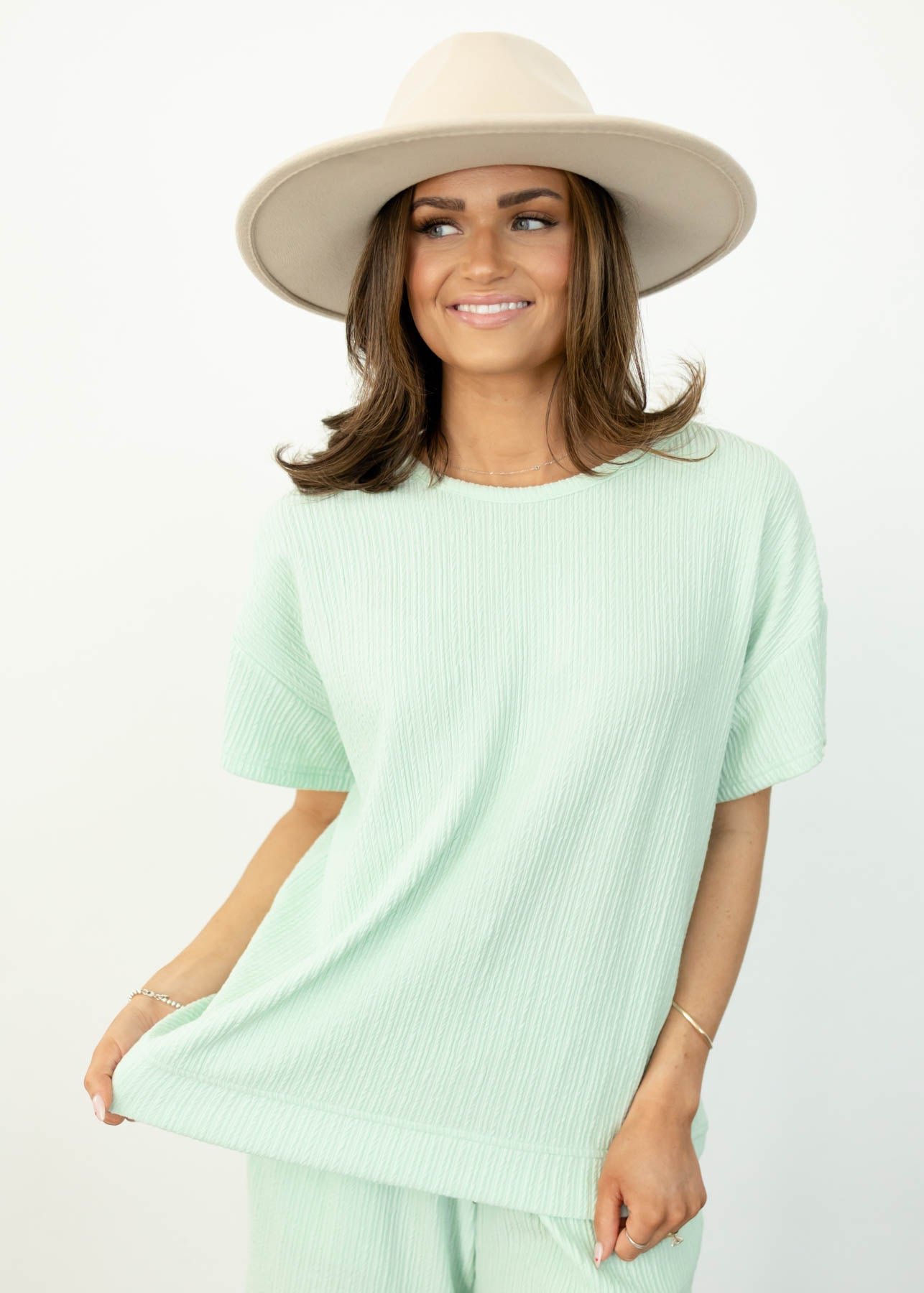 Front view of a short sleeve sage top