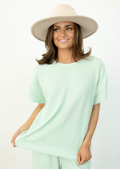 Front view of a short sleeve sage top