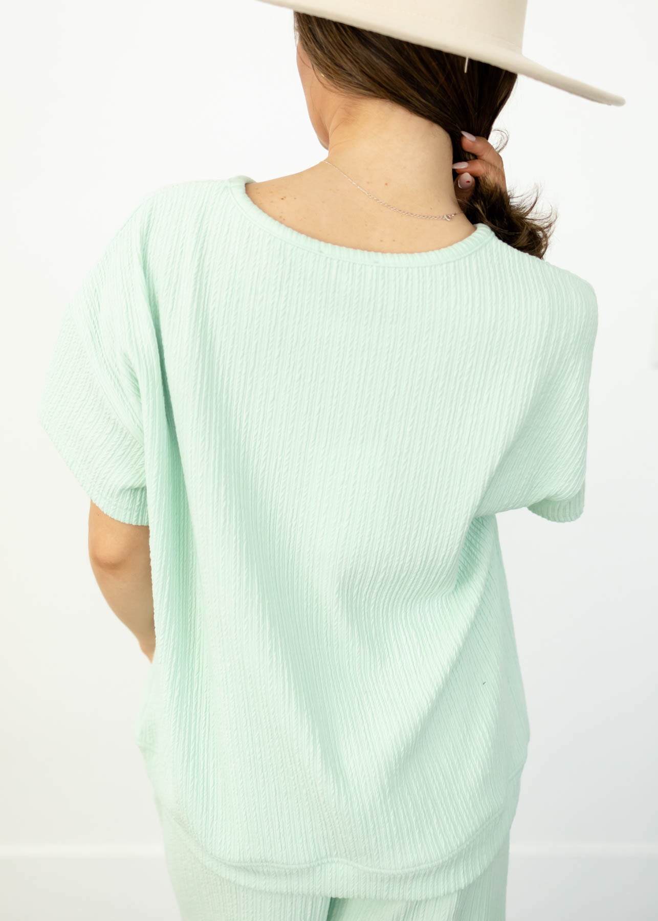 Back view of a short sleeve sage top