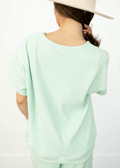 Back view of a short sleeve sage top