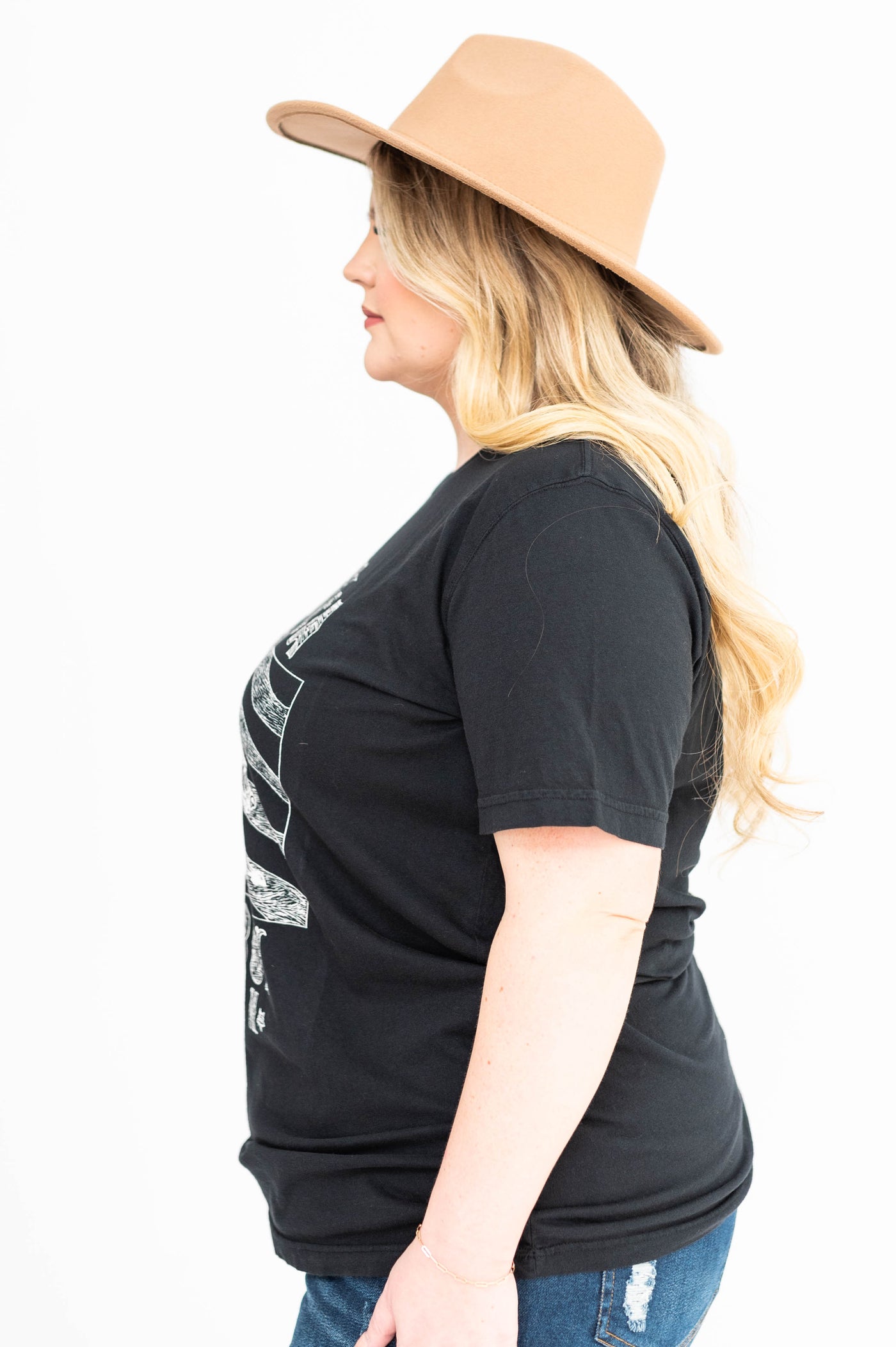 Side view of a plus size cowboy black tee