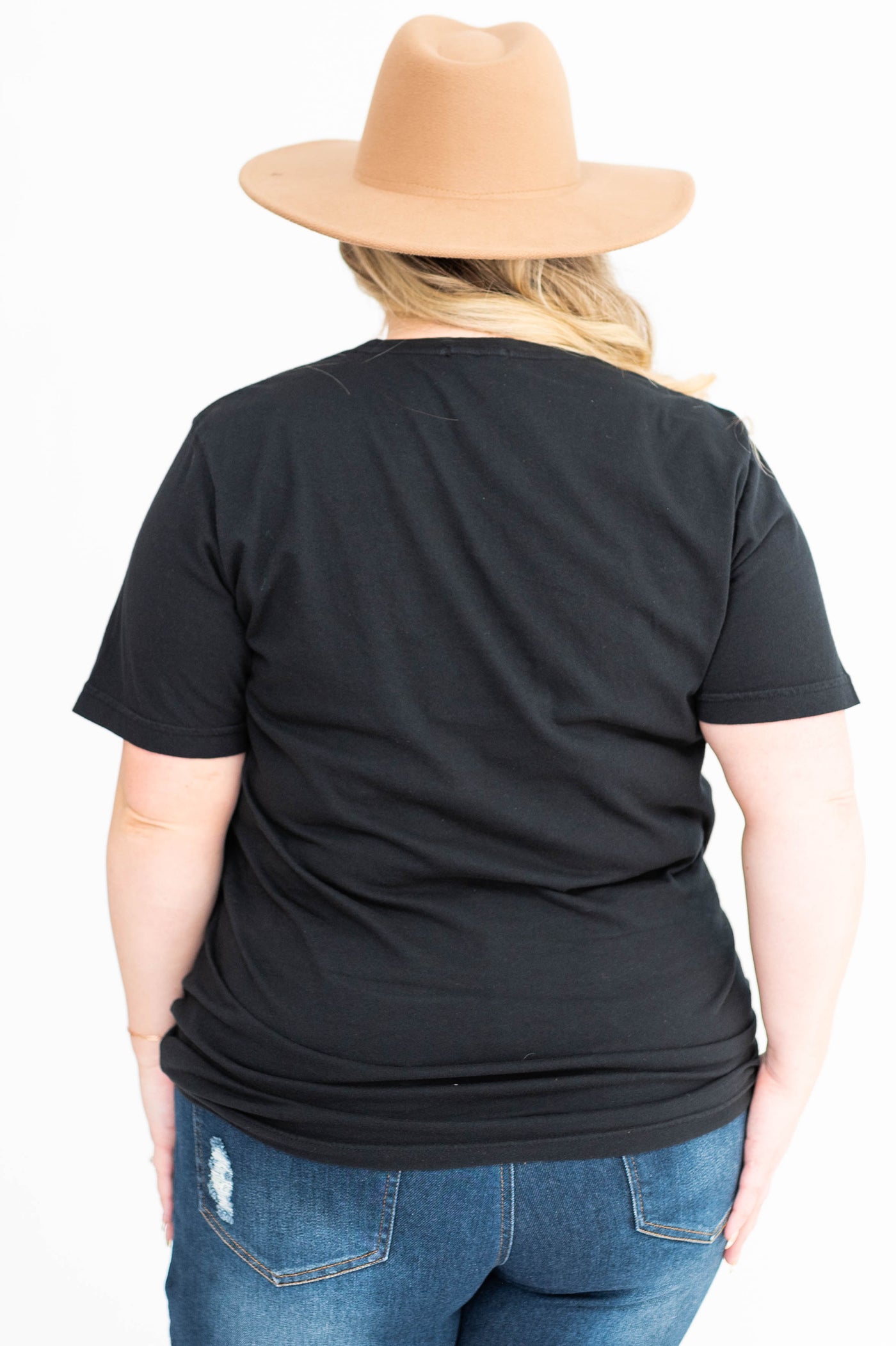Back view of a cowboy black tee
