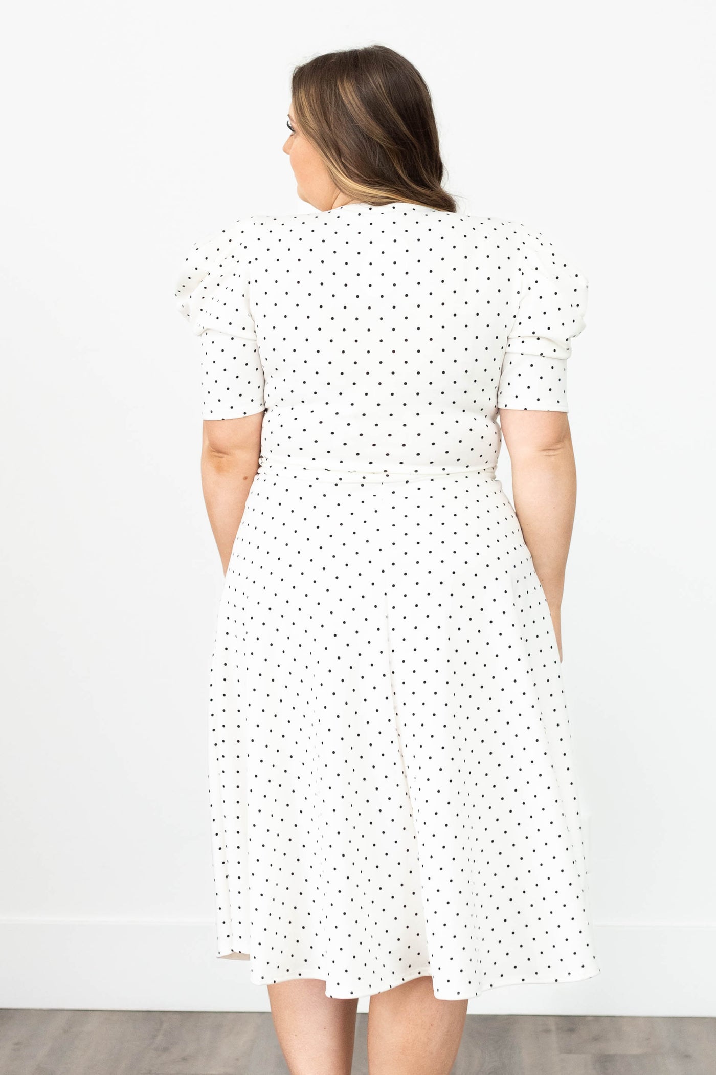 Back view of a plus size white dot dress