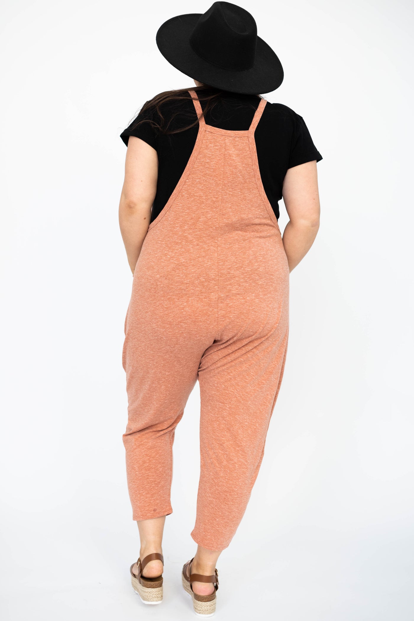 Back view of a plus size rust jumpsuit