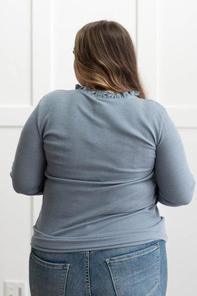 Back view of a plus size blue knit top