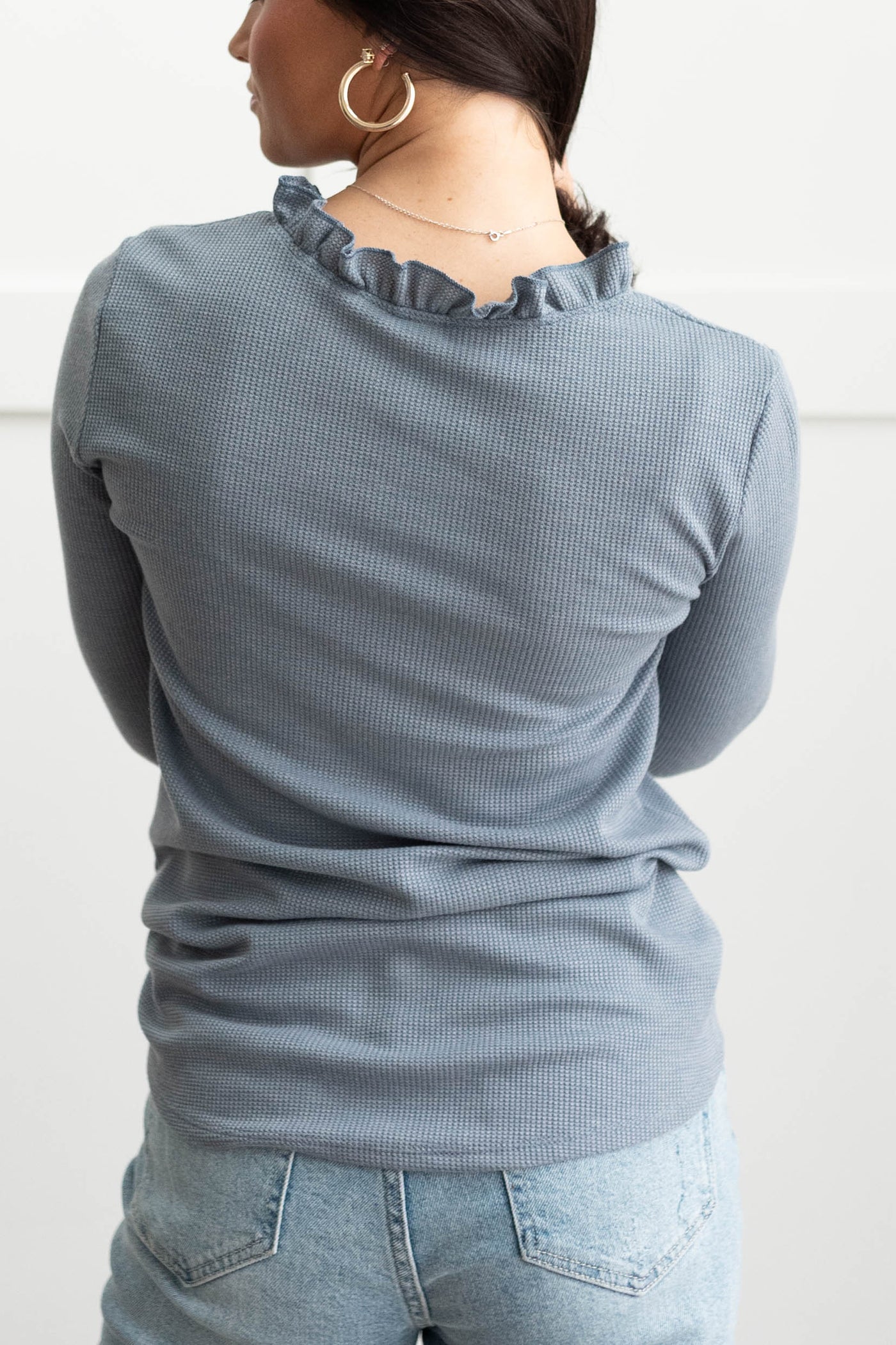 Back view of a blue knit top
